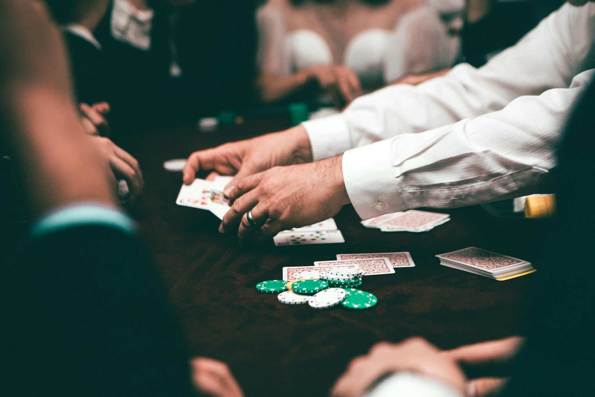 póker bots para juegos de cash – jugadores concentrados alrededor de una mesa de póker con cartas y fichas que ilustran un juego disciplinado