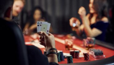 player holding pocket aces at a poker table during an online tournament with a poker bot